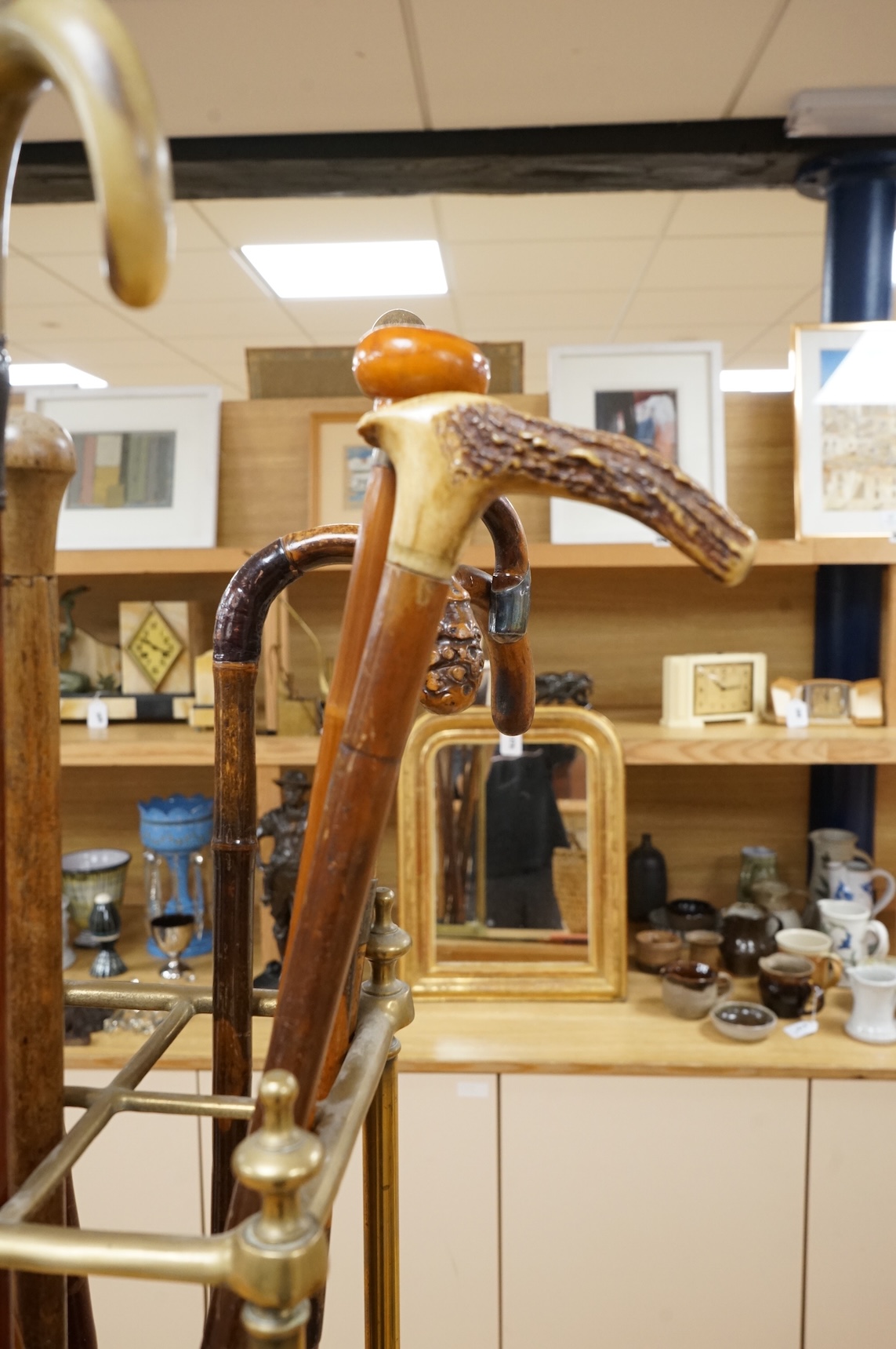 A collection of various walking sticks, some silver mounted and a brass stick stand, 67cm high